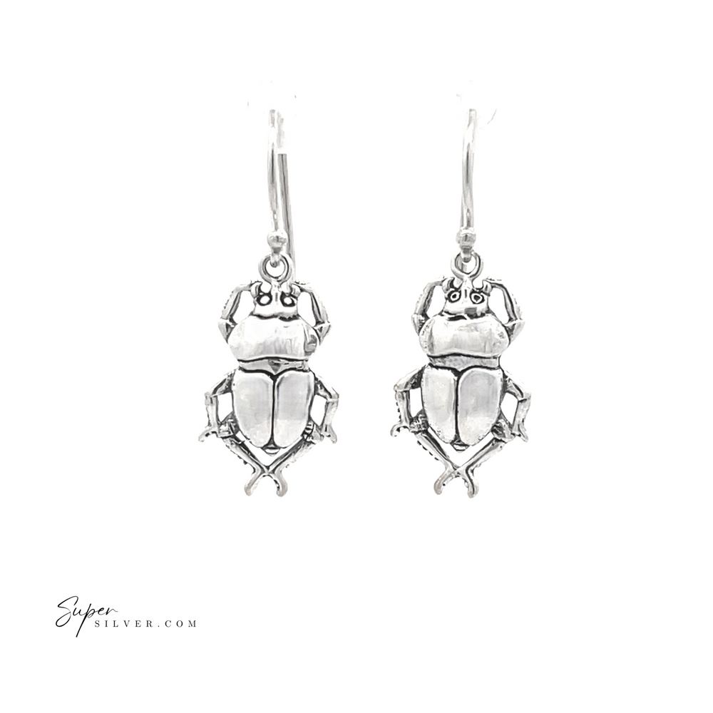 
                  
                    A pair of Beetle Earrings in sterling silver, set against a white background, inspired by ancient Egyptian jewelry.
                  
                