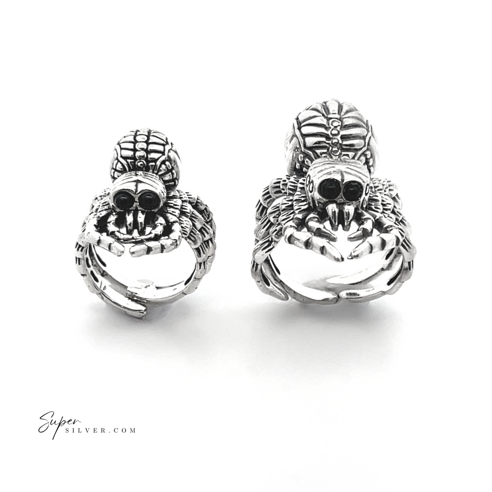 
                  
                    Two intricately designed Adjustable Statement Spider Rings crafted from sterling silver, showcasing detailed features on a white background. This exquisite piece of handcrafted jewelry highlights the artful precision and unique elegance inspired by nature's design.
                  
                