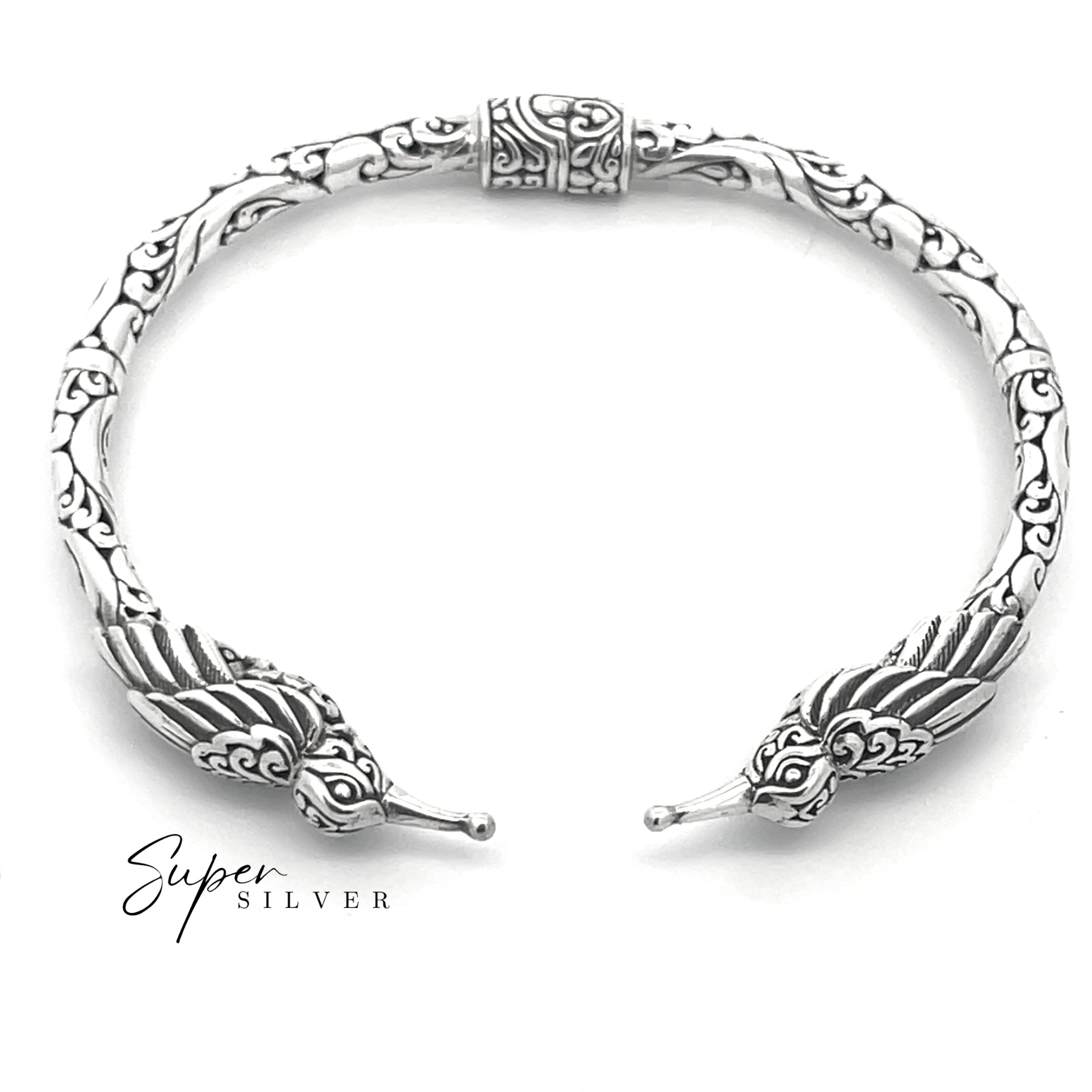 The Enchanting Hummingbird Hinge Bracelet, a sterling silver cuff with intricate patterns and stylized bird head ends, is shown on a white background featuring the "Super Silver" text in the corner.