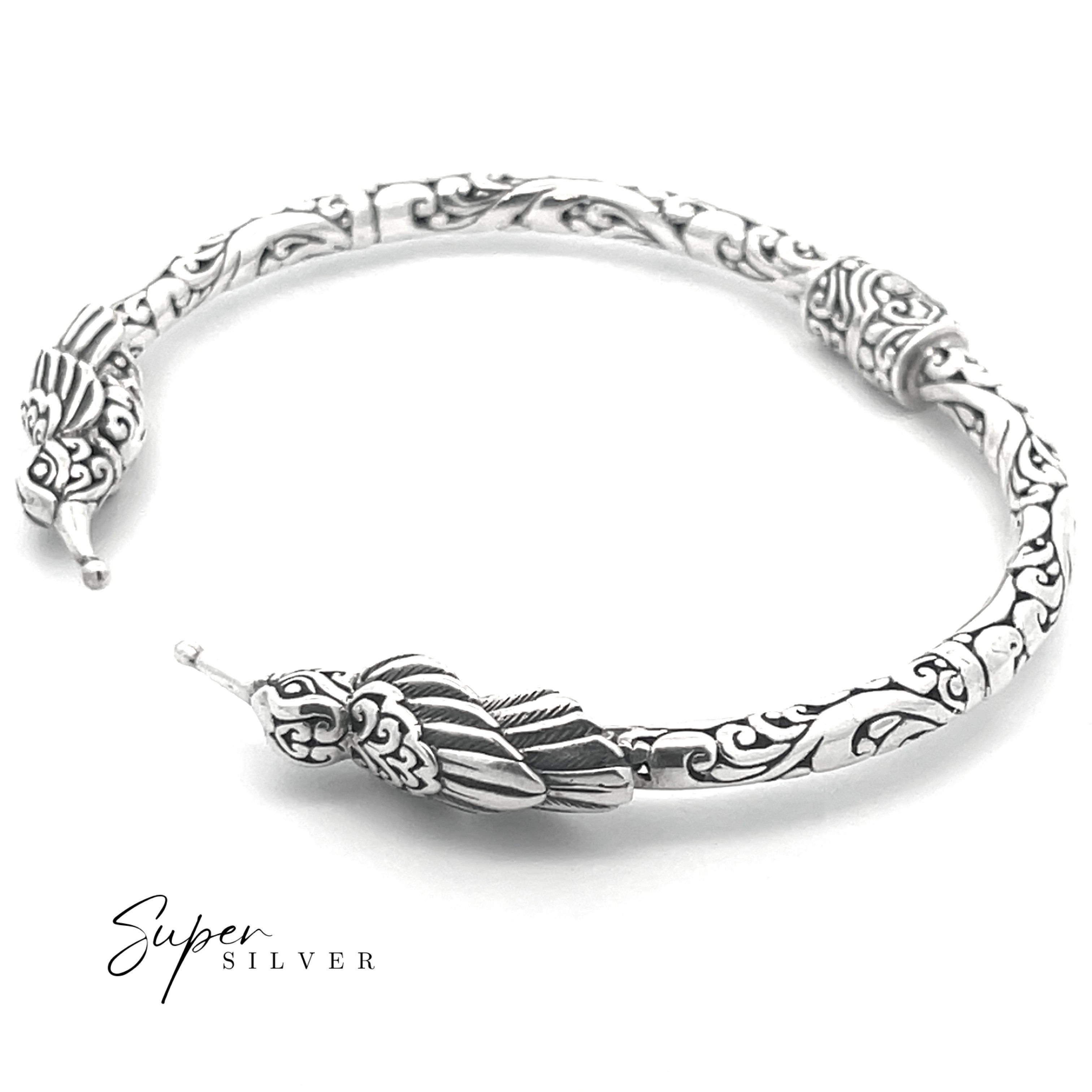 The Enchanting Hummingbird Hinge Bracelet, crafted in sterling silver with intricate patterns and a decorative hummingbird clasp, is displayed on a white background with the "Super Silver" logo.