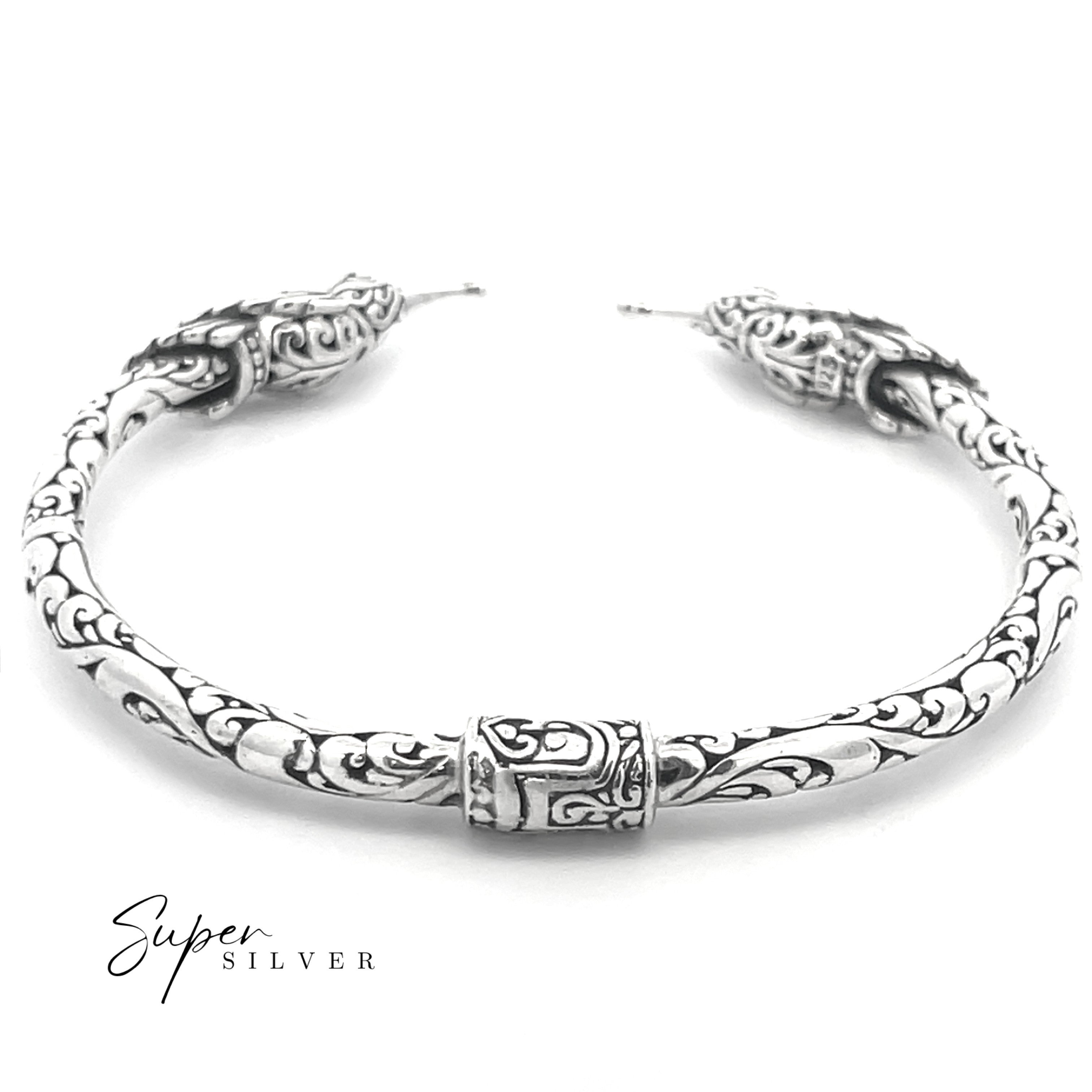 The Enchanting Hummingbird Hinge Bracelet is a handcrafted sterling silver cuff with intricate engraved patterns and decorative end caps, shown on a white background with "Super Silver" in the corner.