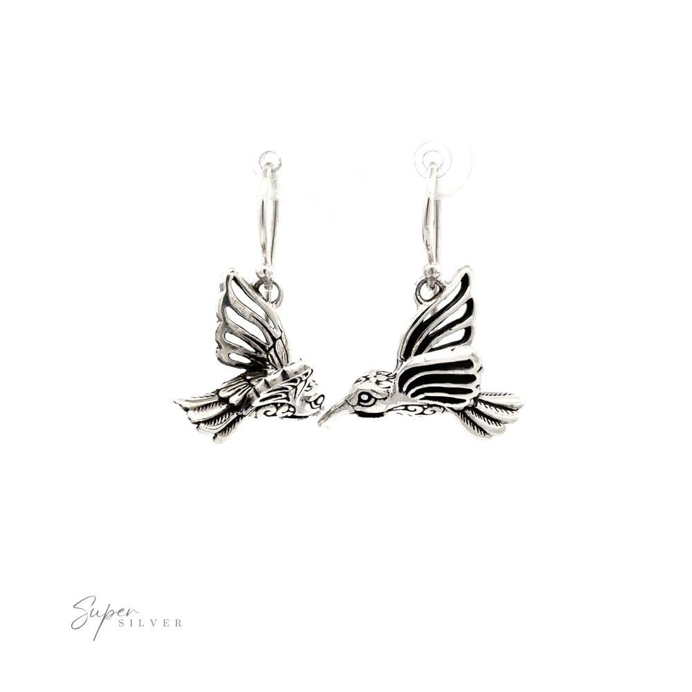 
                  
                    A pair of Filigree Hummingbird Earrings shaped like hummingbirds in mid-flight, each with intricate detailing on the wings and body, displayed against a white background.
                  
                