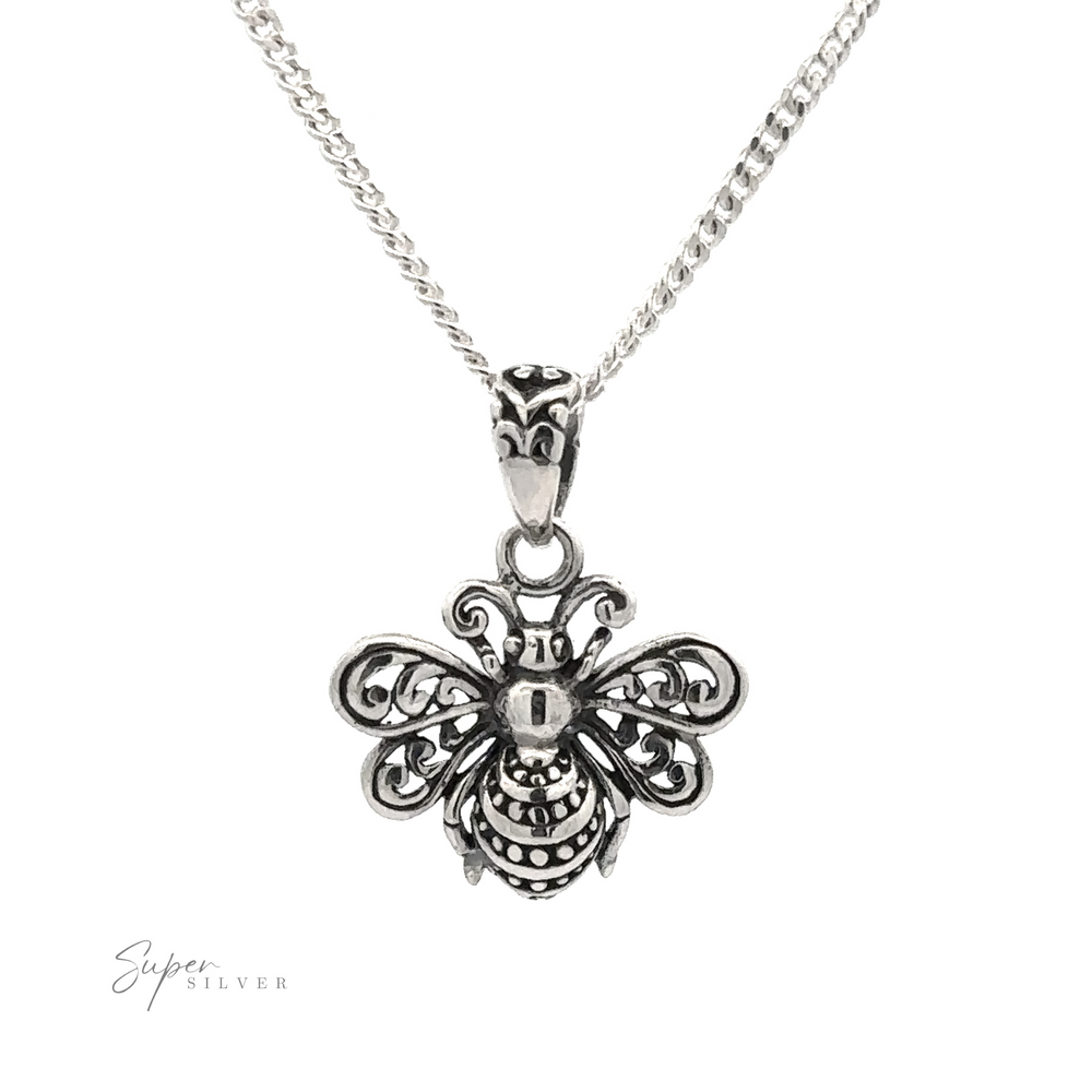 
                  
                    The Filigree Bee Pendant, crafted from .925 Sterling Silver, features intricate detailing and hangs elegantly on a fine chain necklace against a white background. This piece of artisan jewelry is both delicate and stunning.
                  
                