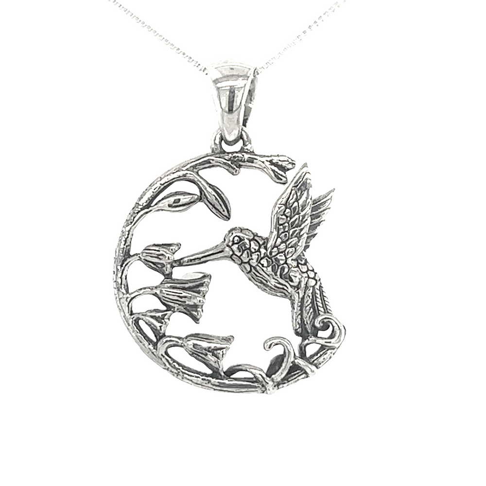 A beautiful Floral Hummingbird Pendant on a chain, crafted with .925 sterling silver, by Super Silver.