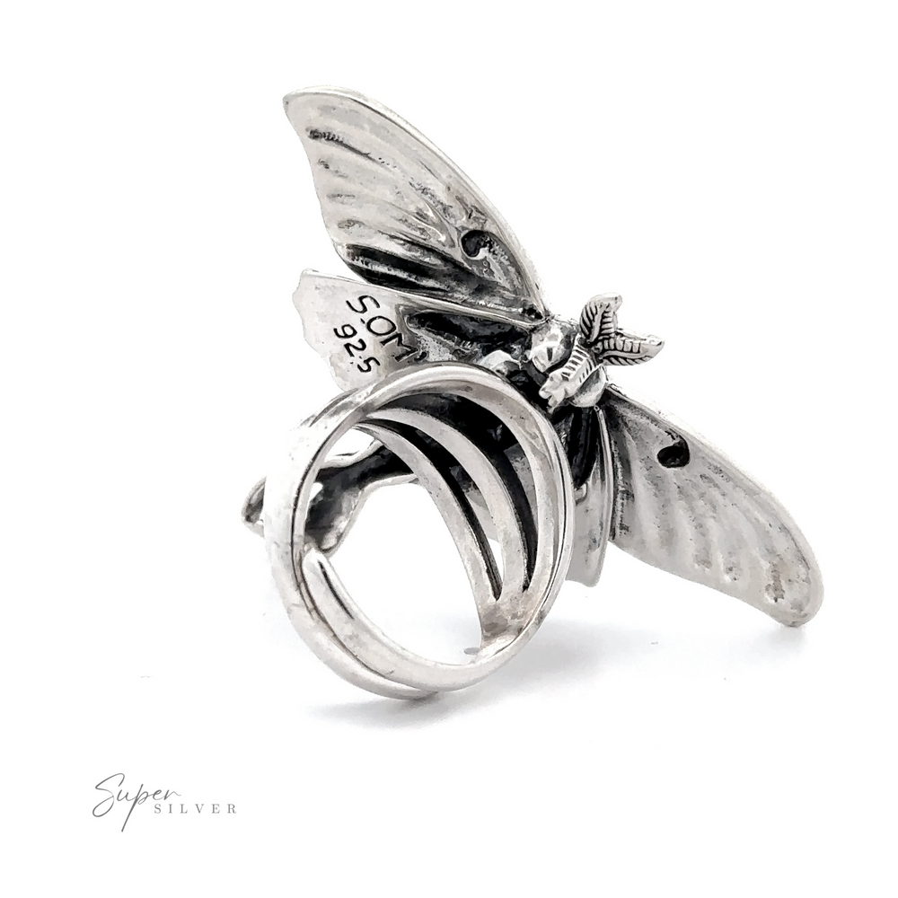 
                  
                    A Statement Lunar Moth Ring with detailed wings and body, marked "925" indicating sterling silver, on a plain white background.
                  
                