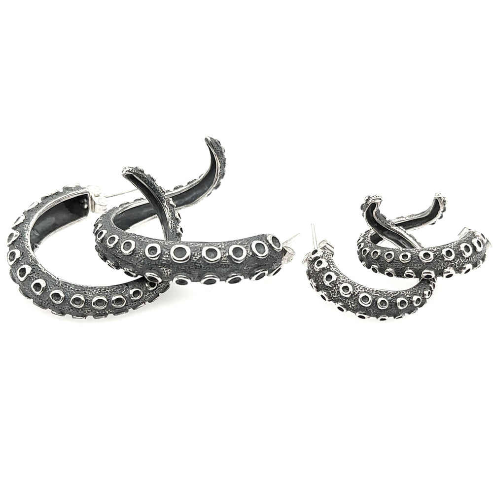 
                  
                    A pair of Edgy Octopus Tentacle Hoop Earrings inspired by oceanic charm, showcasing their unique design on a white background, by Super Silver.
                  
                