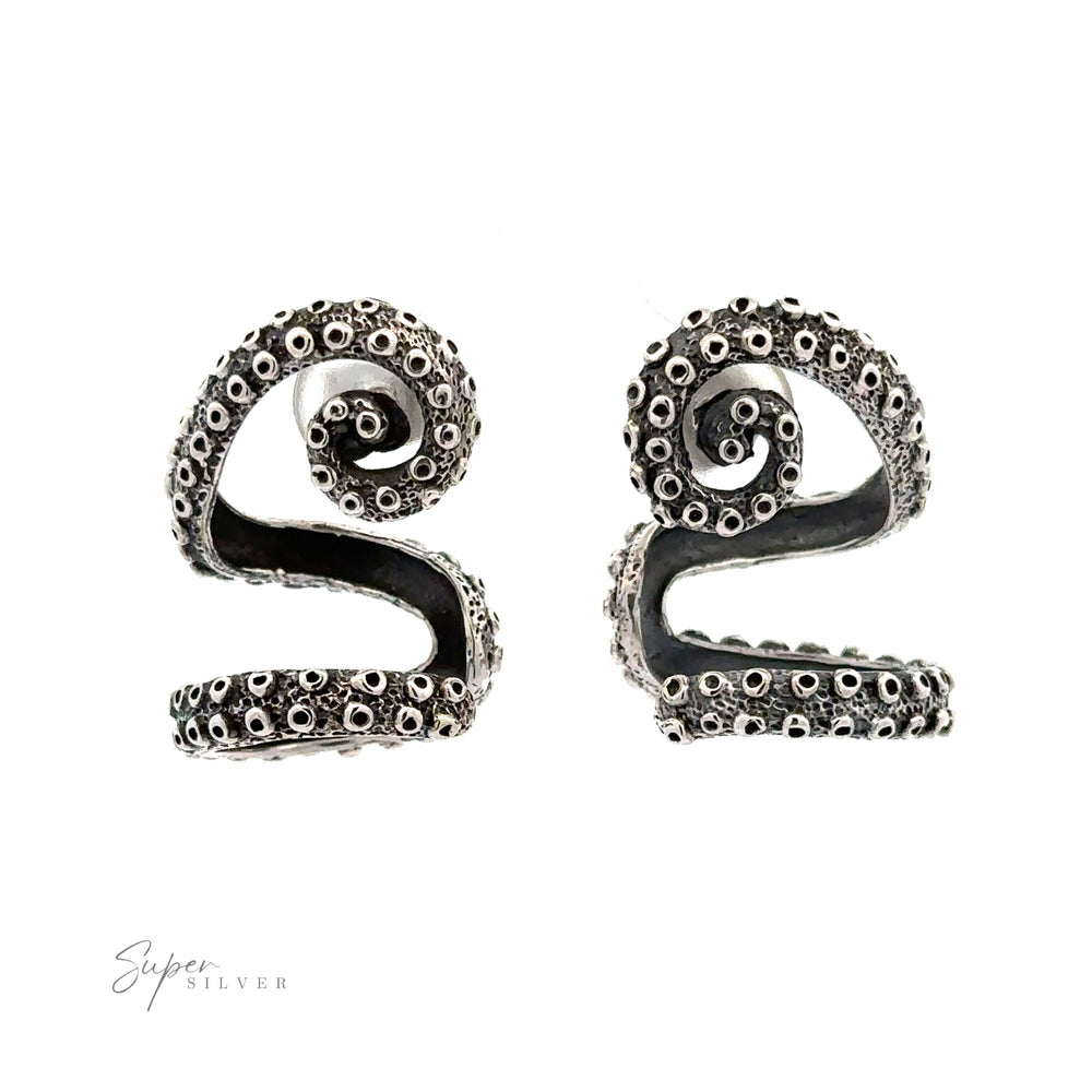 A pair of handcrafted sterling silver earrings designed to resemble octopus tentacles, featuring intricate details and a spiral shape. The logo "Super Silver" is visible in the lower left corner. These Curled Tentacle Earrings perfectly capture the essence of ocean allure jewelry.