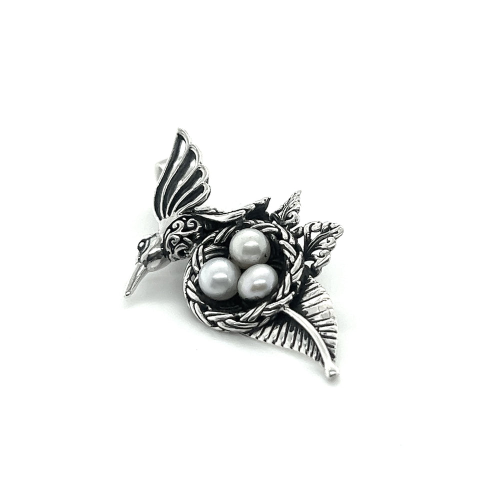 A Super Silver Hummingbird Pendant with Nest of Pearls.