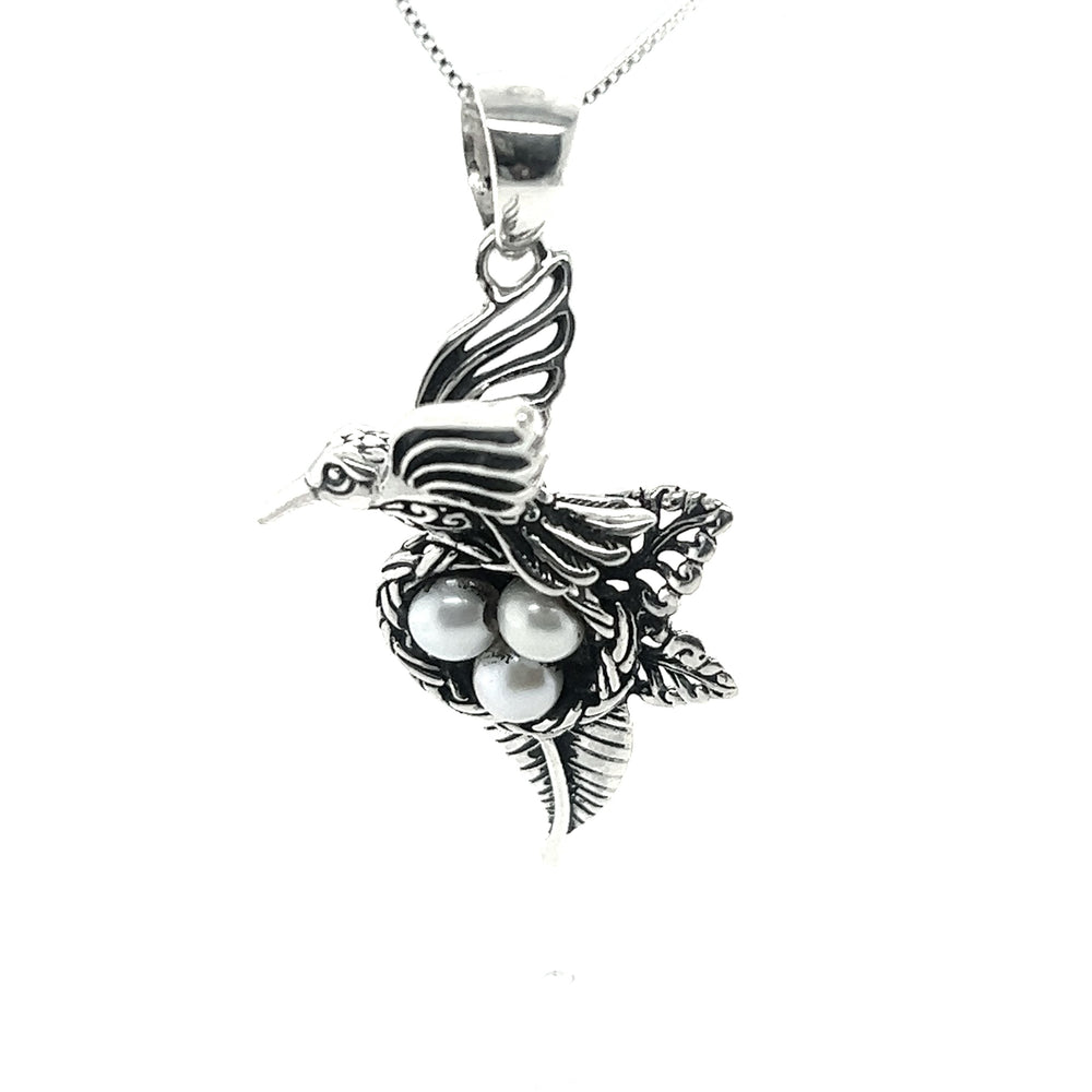 
                  
                    A Super Silver Hummingbird Pendant with Nest of Pearls, showcasing exquisite craftsmanship in jewelry design.
                  
                