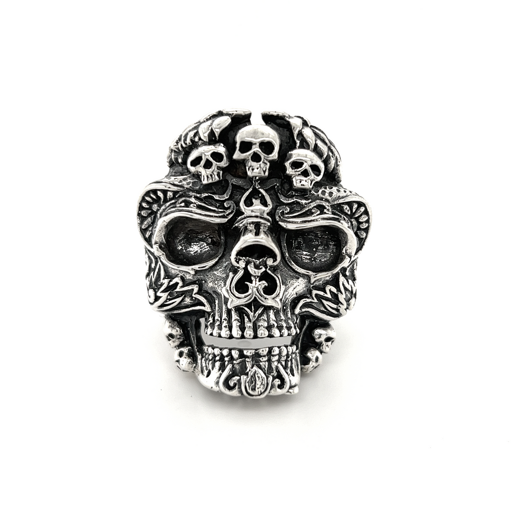 An Exquisite Skull Ring adorned with silver skulls, part of a unique jewelry line.