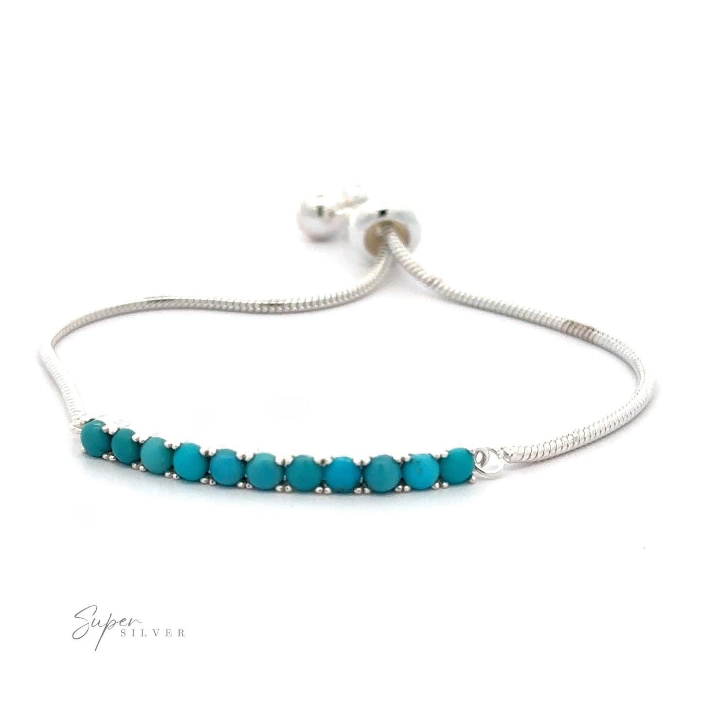 A Silver Adjustable Bracelet with American Turquoise features an adjustable snake chain design adorned with a row of nine small American turquoise beads. The clasp is visible in the background.