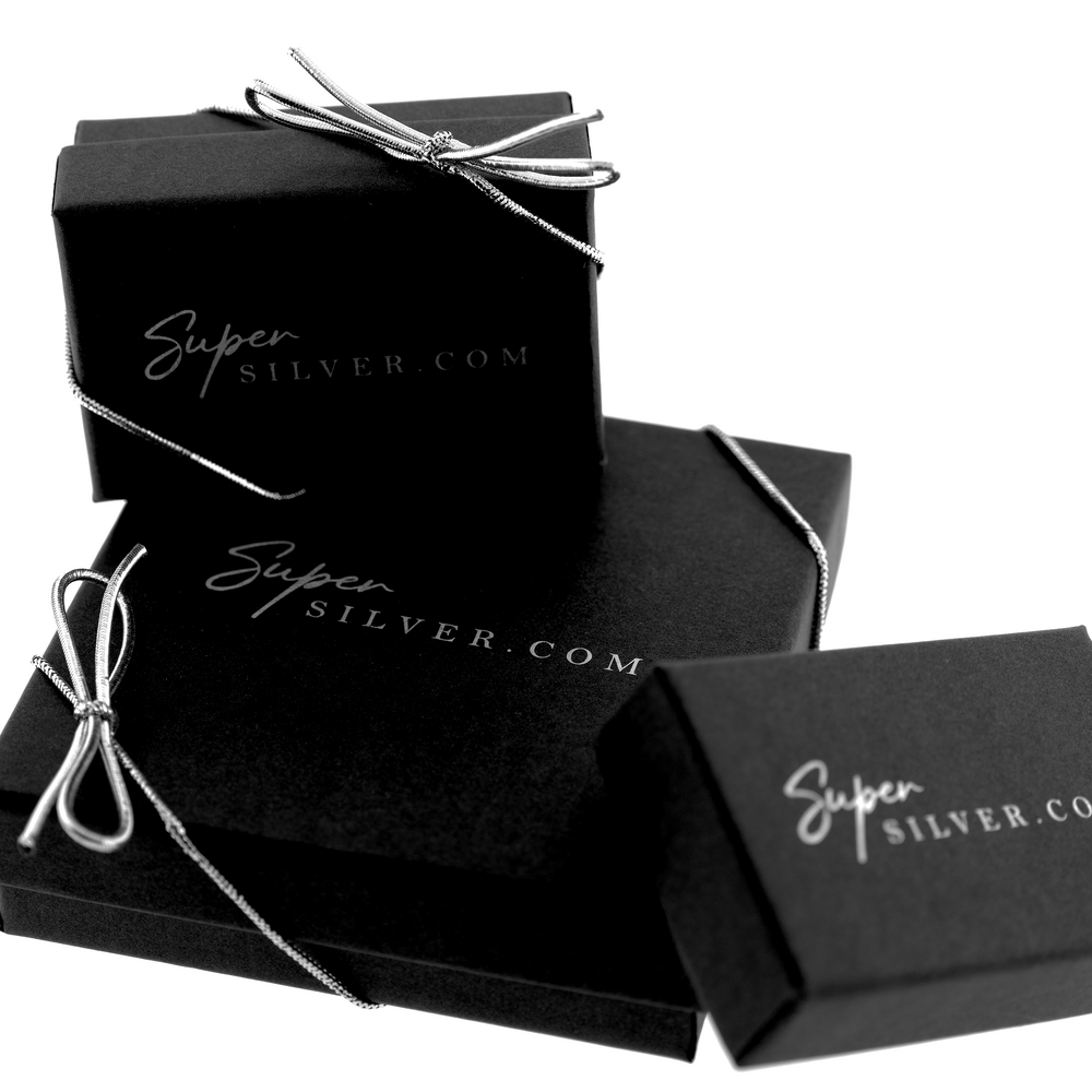 
                  
                    Three black Gift Wrap tied with silver ribbons, each with the inscription "SuperSilver.com," offer a special touch of elegance.
                  
                