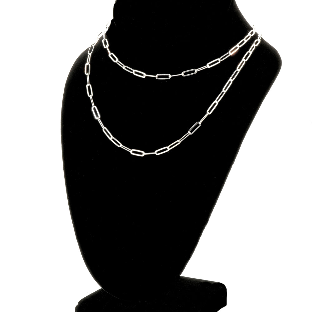 A Sterling Silver Paperclip Chain, embodying contemporary elegance, is beautifully displayed on a black jewelry bust stand. This exquisite piece showcases exceptional Italian craftsmanship, making it a timeless addition to any collection.