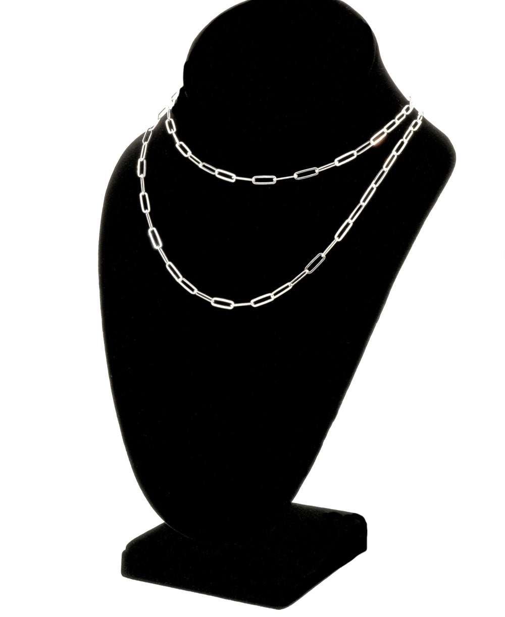 A Sterling Silver Paperclip Chain, embodying contemporary elegance, is beautifully displayed on a black jewelry bust stand. This exquisite piece showcases exceptional Italian craftsmanship, making it a timeless addition to any collection.