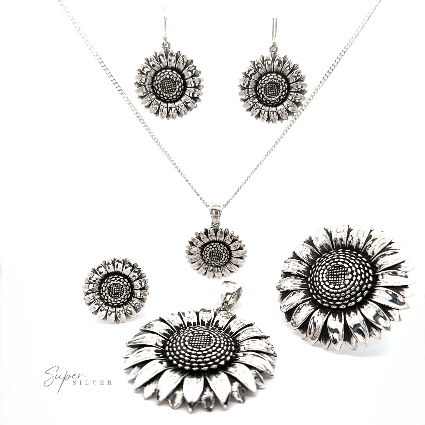
                  
                    Silver sunflower pendant set with an oxidized finish, including earrings, necklaces, and brooches displayed on a white background.
                  
                