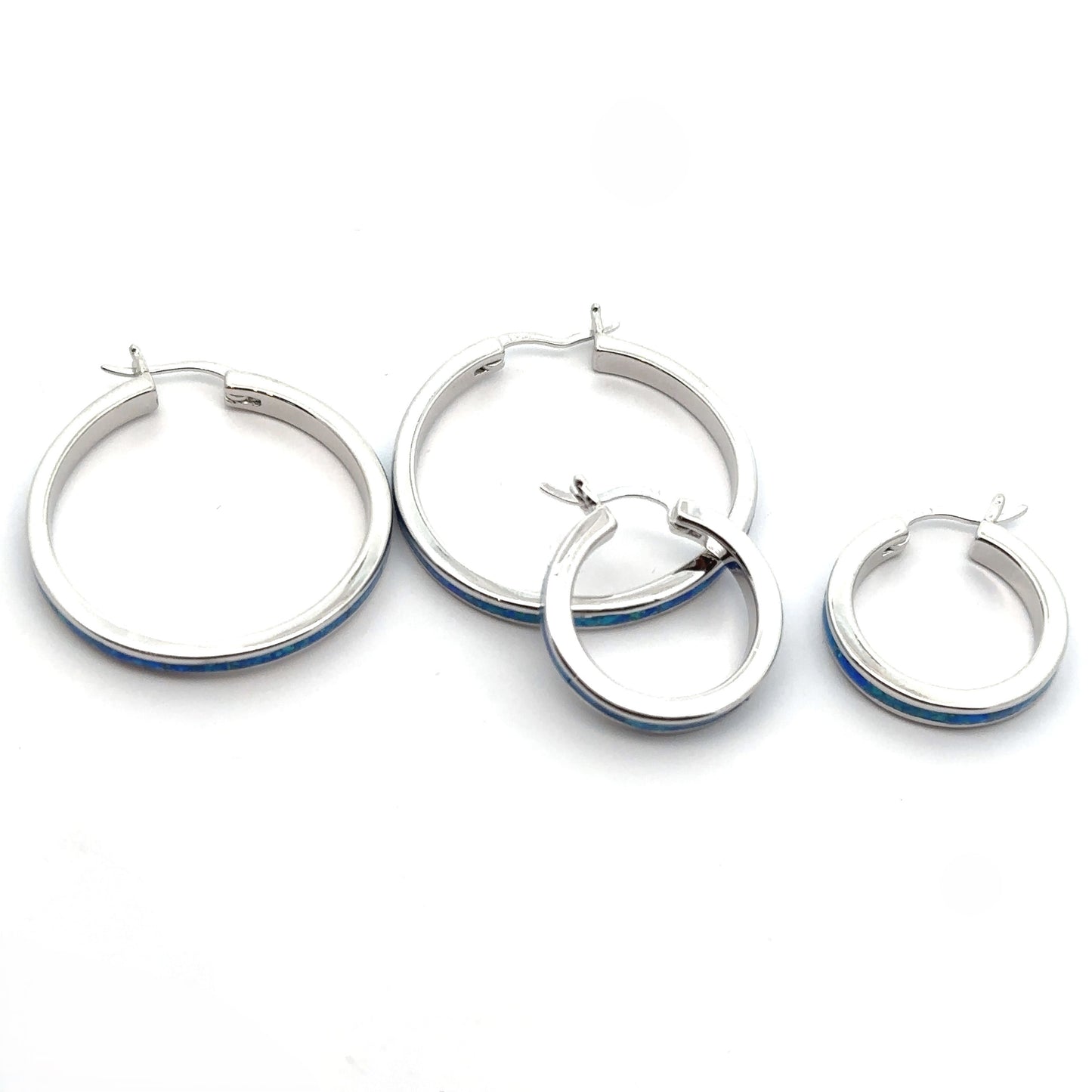 
                  
                    Blue Lab-Created Opal hoop earrings, available in two distinct sizes, stylishly displayed on a white background. The sparkling rhodium finish adds to their allure and sophistication.
                  
                