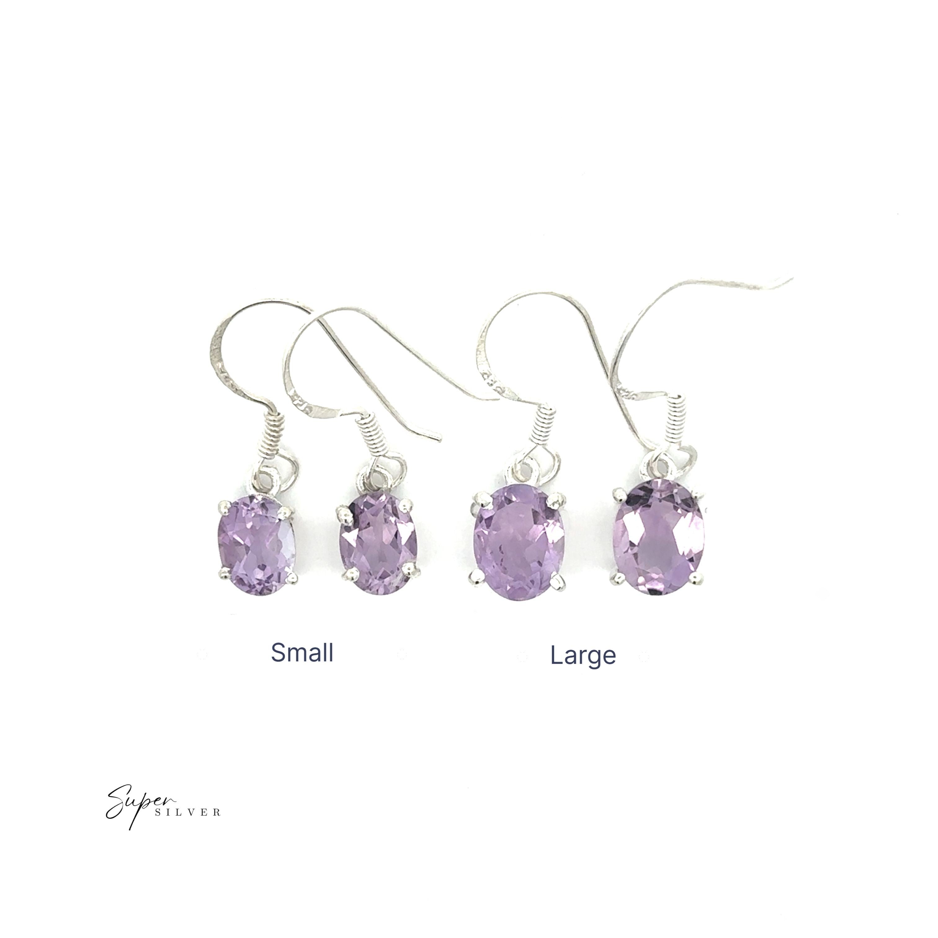 Two pairs of Brilliant Oval Gemstone Earrings—one small and one large—featuring silver hooks, are displayed side by side on a white background.