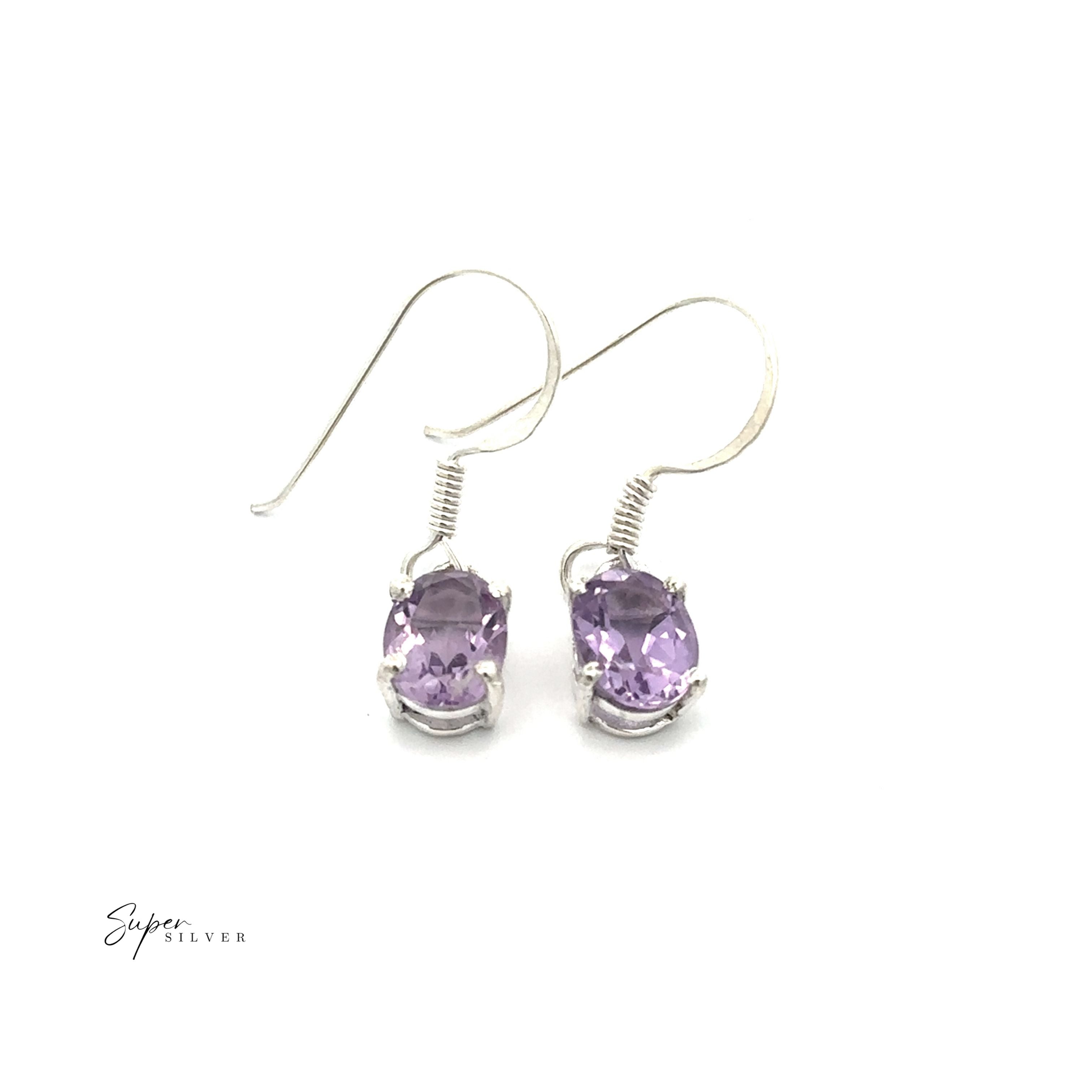 Brilliant Oval Gemstone Earrings: Sterling silver earrings with prong-set, oval-cut light purple gemstones, elegantly shown on a plain white background.