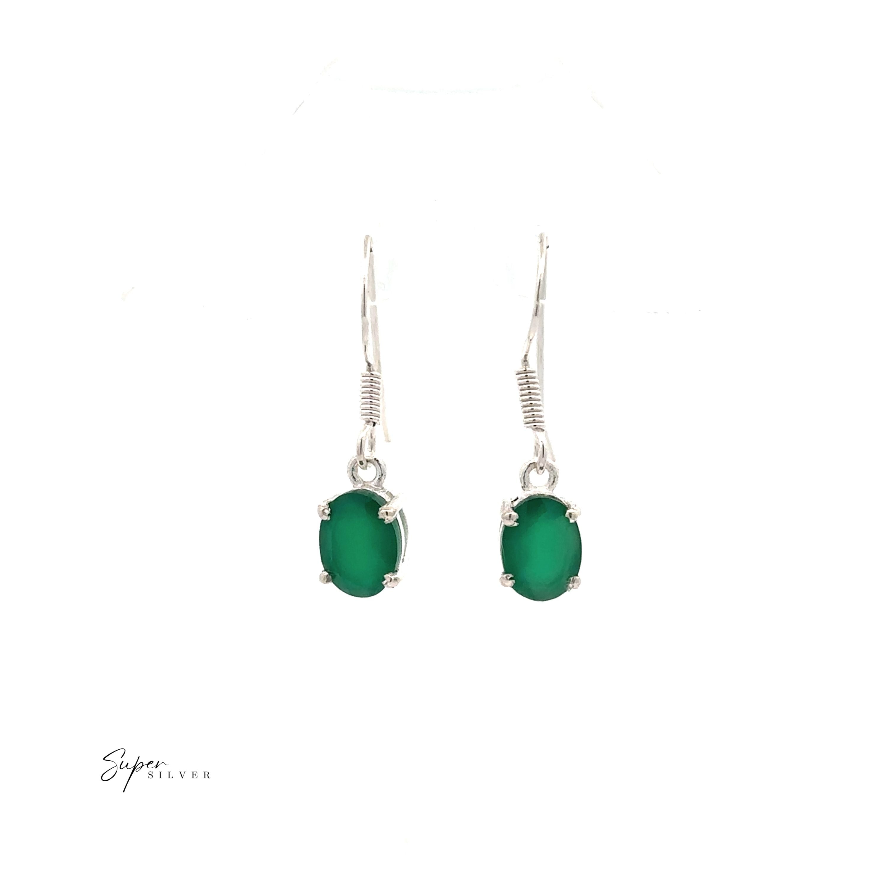 The Brilliant Oval Gemstone Earrings are sterling silver drop earrings with oval green gemstones in prong settings, shown on a white background.