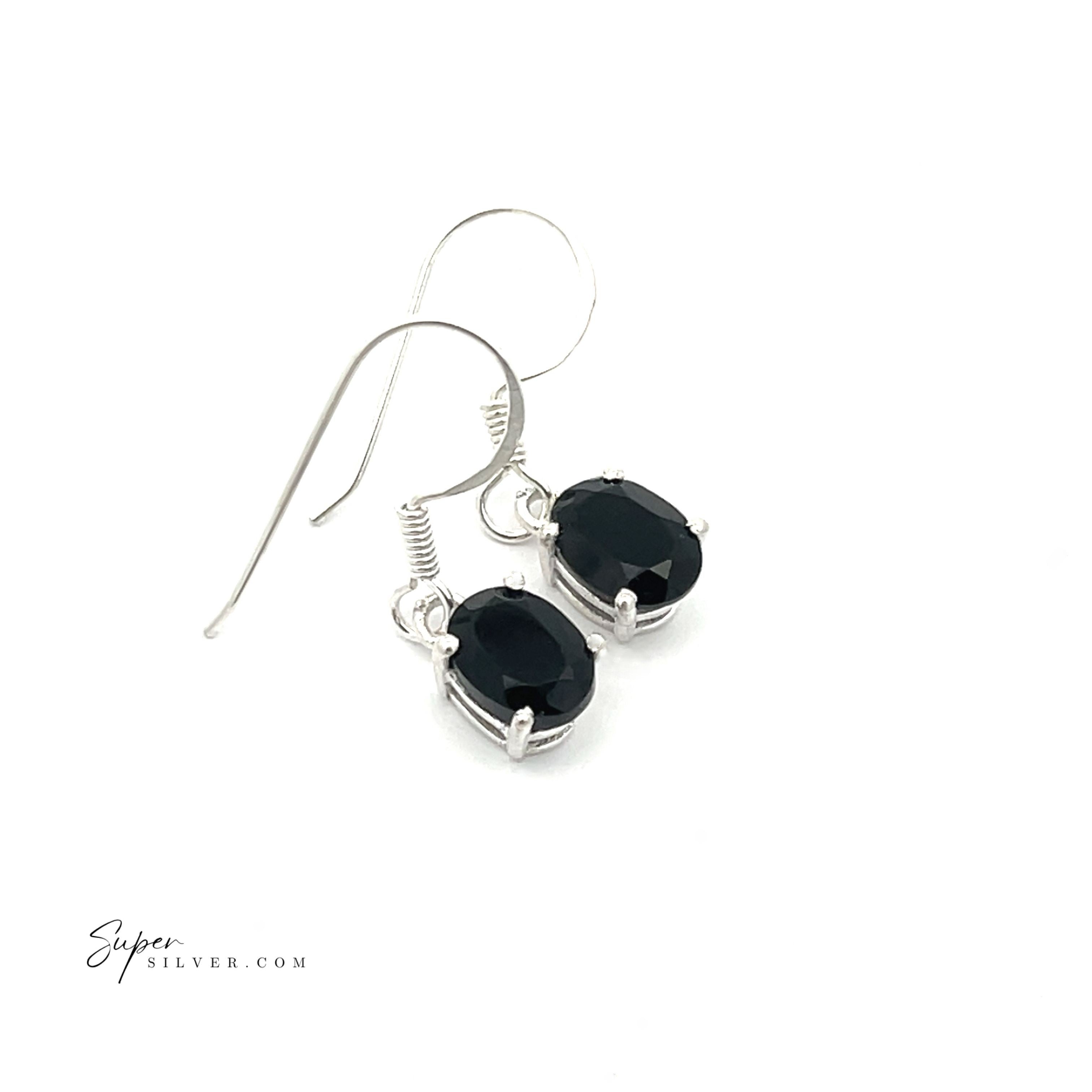 Brilliant Oval Gemstone Earrings: Sterling silver earrings featuring oval faceted black stones, prong-set for security, showcased against a white background.