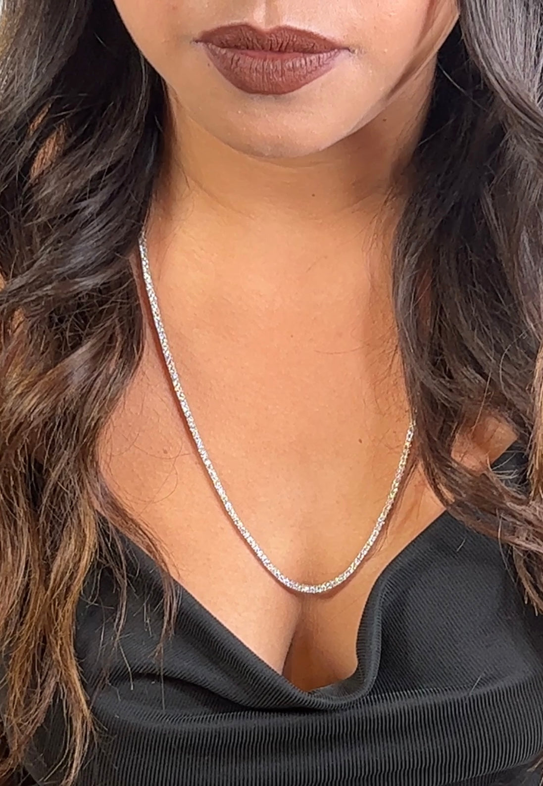 A woman wearing a Super Silver cubic zirconia tennis necklace.