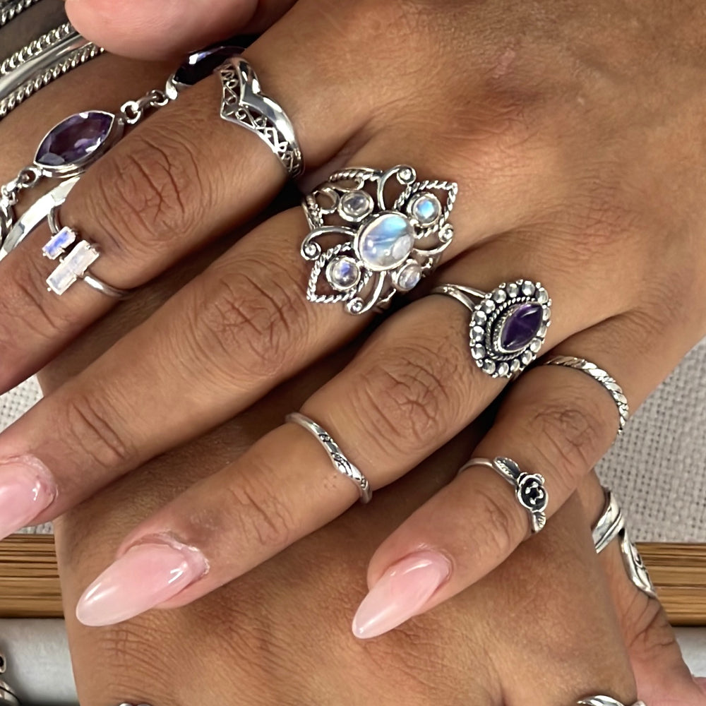 
                  
                    A woman's hand adorned with a collection of Super Silver's Online Only Exclusive Moonstone Rings, featuring enchanting moonstone crystals.
                  
                