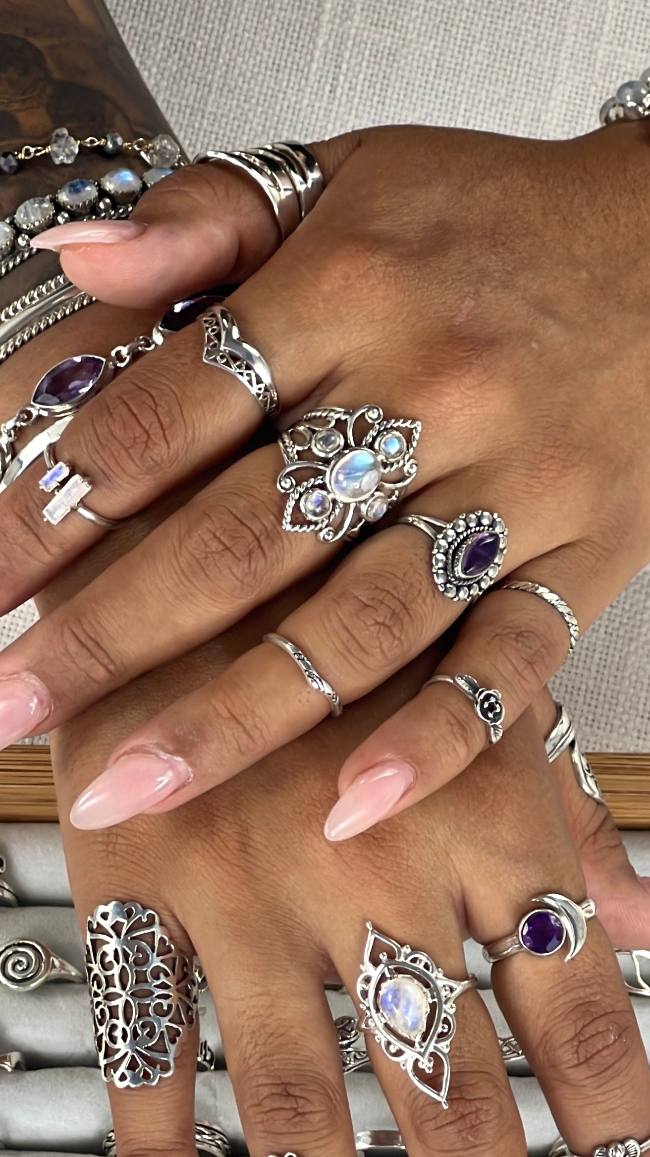 
                  
                    A woman's hand adorned with a collection of Super Silver's Online Only Exclusive Moonstone Rings, featuring enchanting moonstone crystals.
                  
                