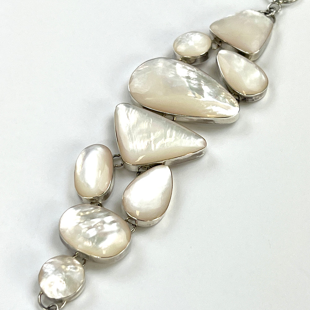 
                  
                    A luminous Statement Mother of Pearl Bracelet by Super Silver on a white surface.
                  
                