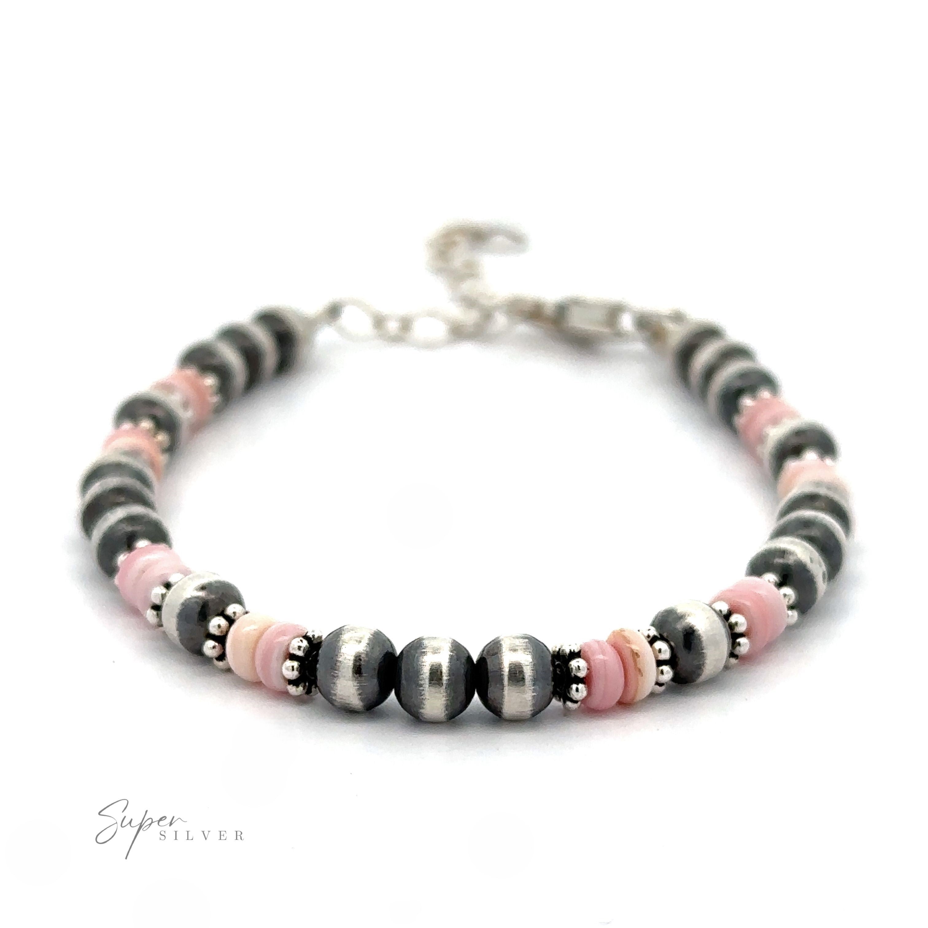 A bracelet composed of alternating Native American Shell and Navajo Pearl beads on a white background.