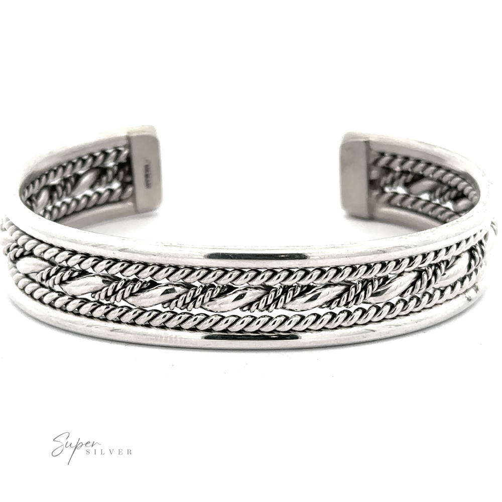 
                  
                    Native American Handmade Intricate Silver Cuff featuring intricate twisted rope designs and an open back, with the brand 'Super Silver' signature visible.
                  
                