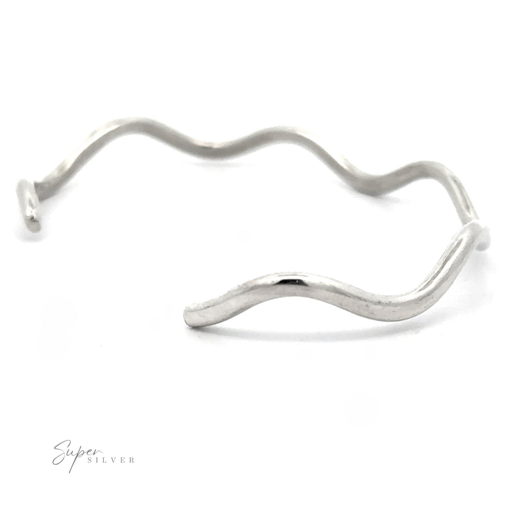 
                  
                    A Native American Handmade Silver Wavy Cuff on a white background. This striking piece of jewelry features an irregular, swerving design without any clasps or embellishments. The text "Super Silver" is visible in the corner.
                  
                
