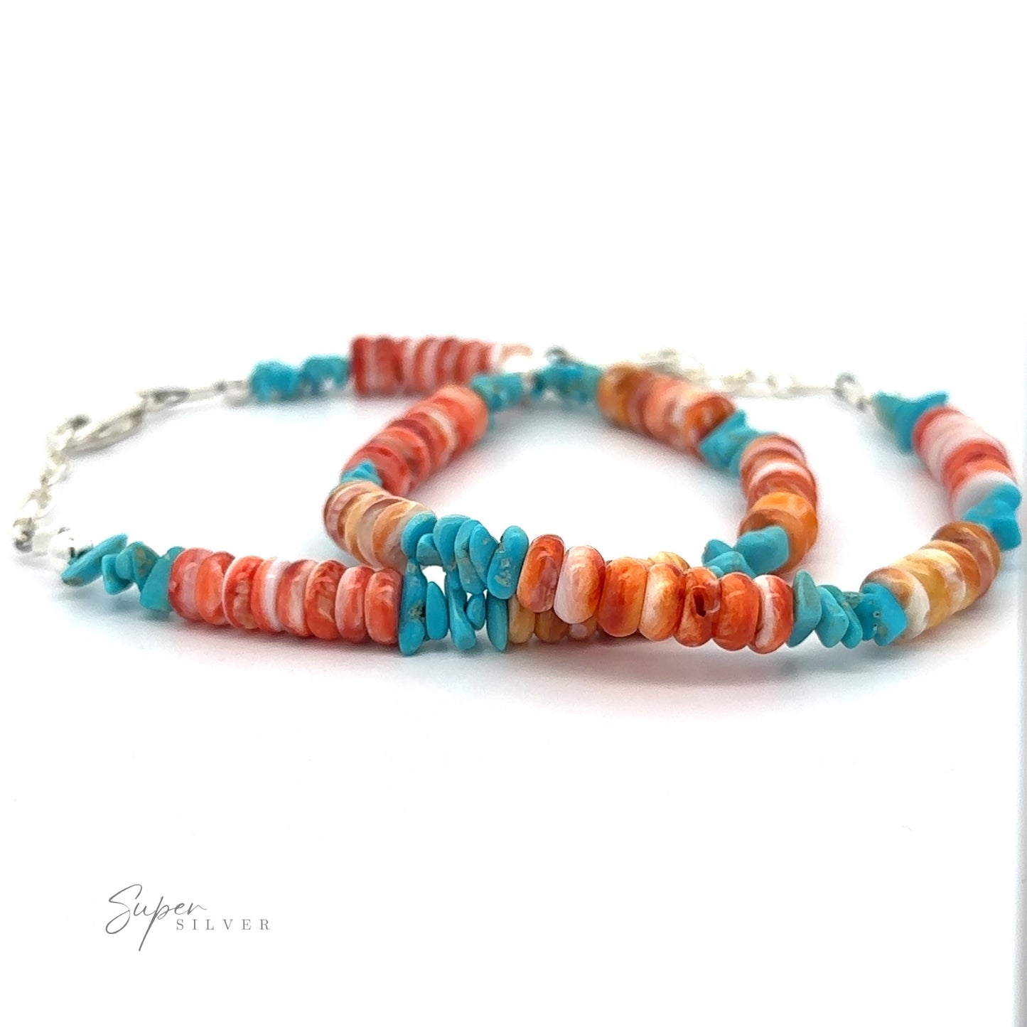 Native American Turquoise and Spiny Oyster Shell Bracelet with alternating turquoise and spiny oyster shell beads, linked by a silver chain, displayed against a white background.