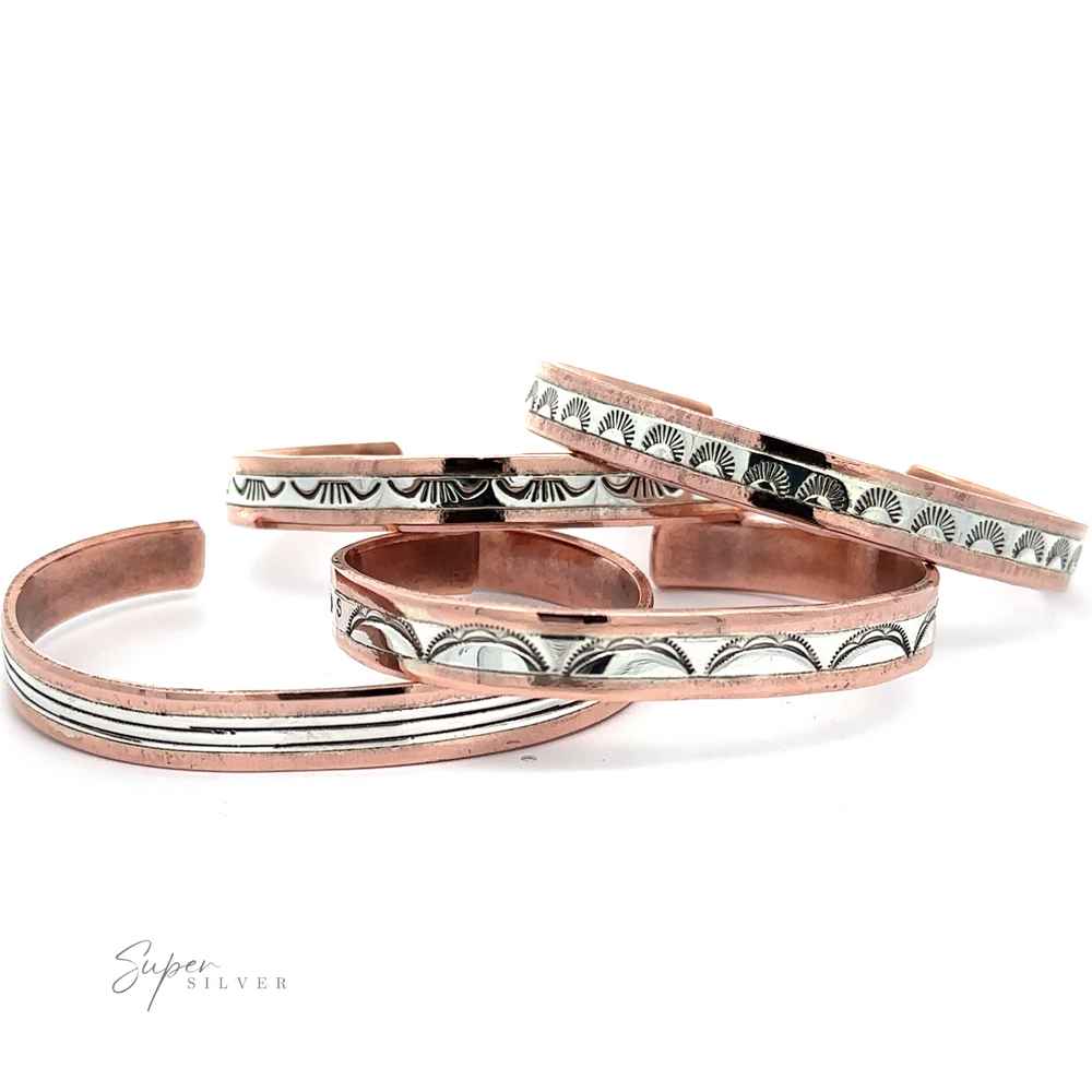 A stunning array of Native American Handmade Copper And Silver Bracelet, each adorned with intricate engraved patterns, are displayed on a white background. The text "Super Silver" is elegantly visible in the bottom left corner.