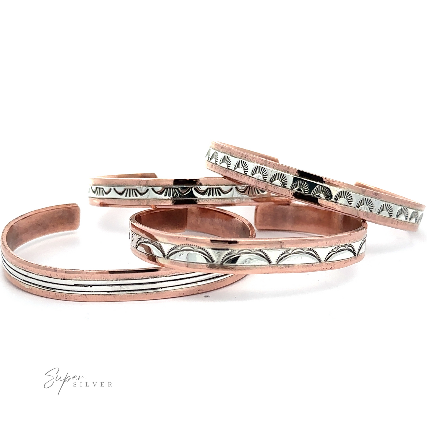 A stunning array of Native American Handmade Copper And Silver Bracelet, each adorned with intricate engraved patterns, are displayed on a white background. The text "Super Silver" is elegantly visible in the bottom left corner.
