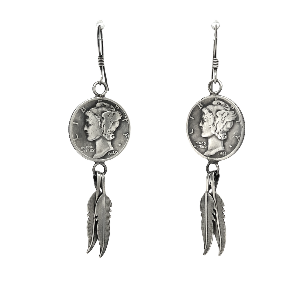 A pair of Super Silver Native American Mercury Dime Earrings adorned with a coin featuring the Winged Liberty Head Dime and delicate feathers.