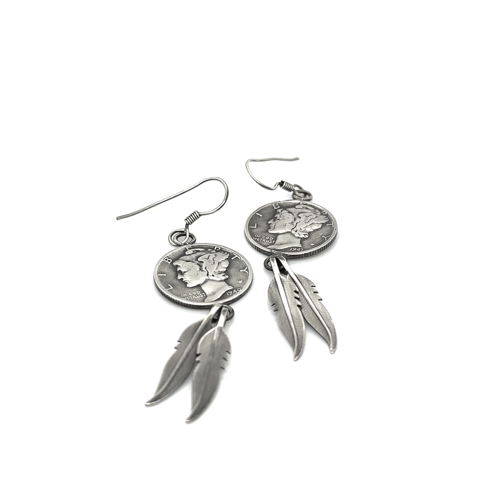 
                  
                    A pair of Native American Mercury Dime Earrings with feathers and a Winged Liberty Head Dime coin by Super Silver.
                  
                