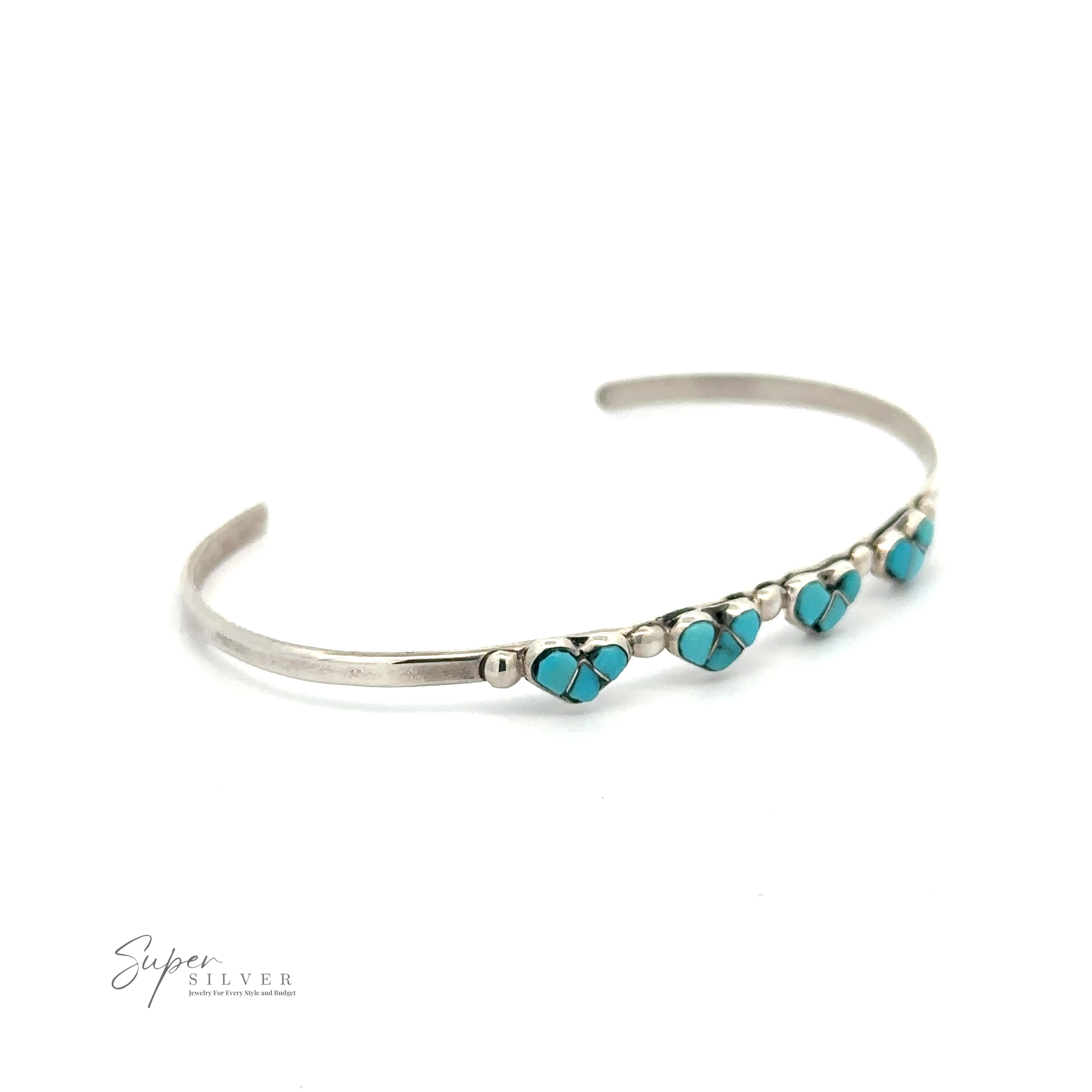 Silver bracelet with small turquoise heart-shaped decorations evenly spaced along the band. Crafted from .925 Sterling Silver, this authentic Native American handmade Turquoise Heart Cuff Bracelet perfectly showcases its craftsmanship. The image has a white background and "Super Silver" logo in the lower left corner.