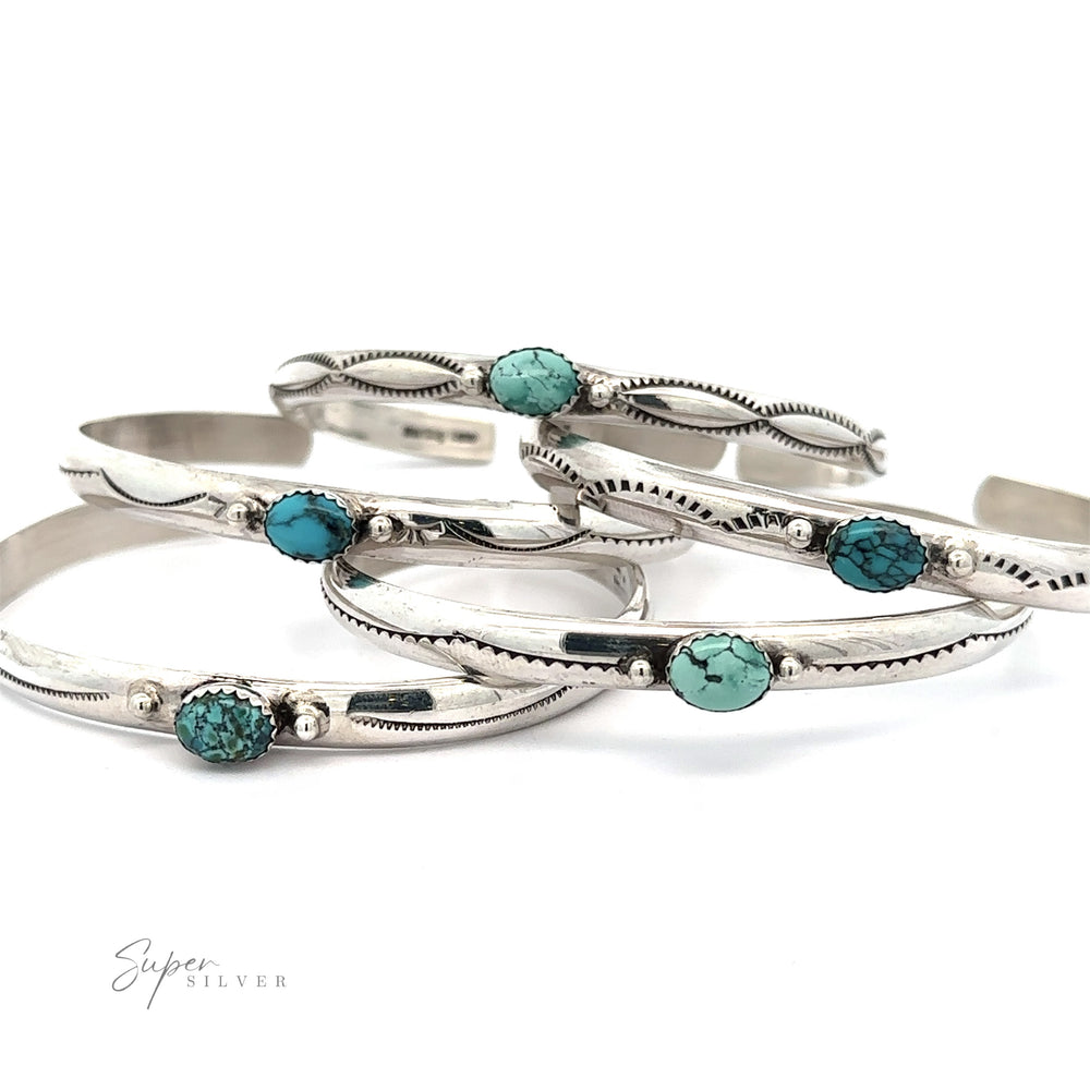 Five Striking Native American Turquoise Cuffs with Diamond Etching are arranged overlapping each other. The design features small, oval-shaped Kingman Turquoise stones. The inscription 