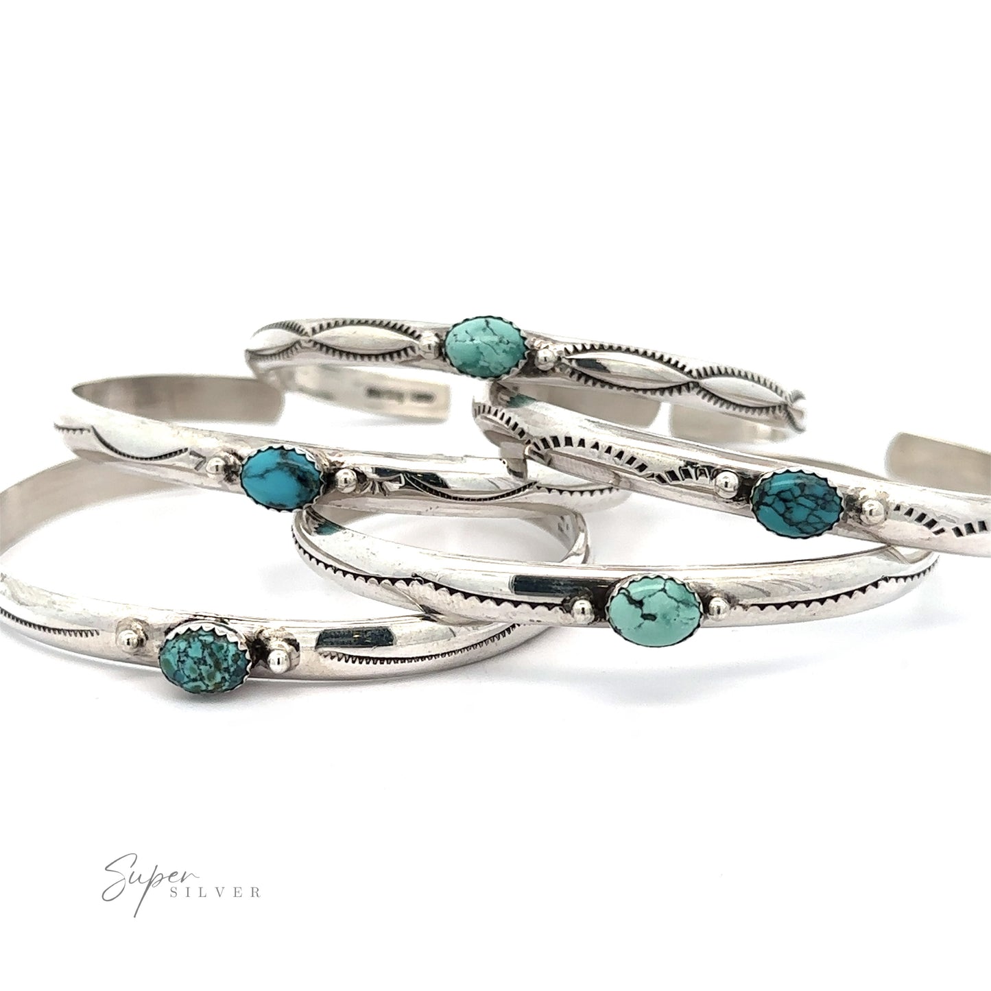 Five Striking Native American Turquoise Cuffs with Diamond Etching are arranged overlapping each other. The design features small, oval-shaped Kingman Turquoise stones. The inscription "Super Silver" is visible in the corner, highlighting the .925 Sterling Silver quality and handcrafted Navajo cuff artistry.