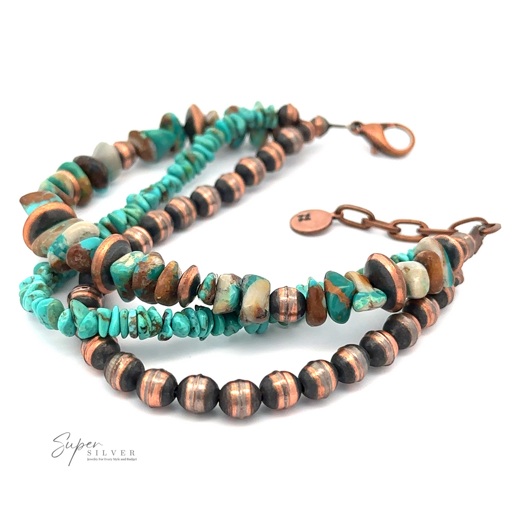 A Copper and Turquoise Native American Beaded Bracelet featuring a mix of turquoise chips and spherical metal beads with copper accents, secured by a lobster clasp.