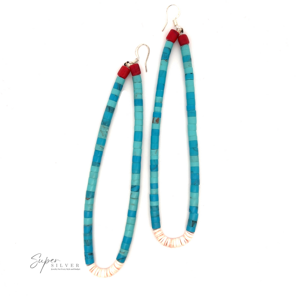 A pair of long, turquoise beaded earrings with off-white cylindrical beads and accented with small red beads at the top. These Long Turquoise Native American Beaded Earrings, featuring hook fastenings, echo the intricate beauty of Native American jewelry.