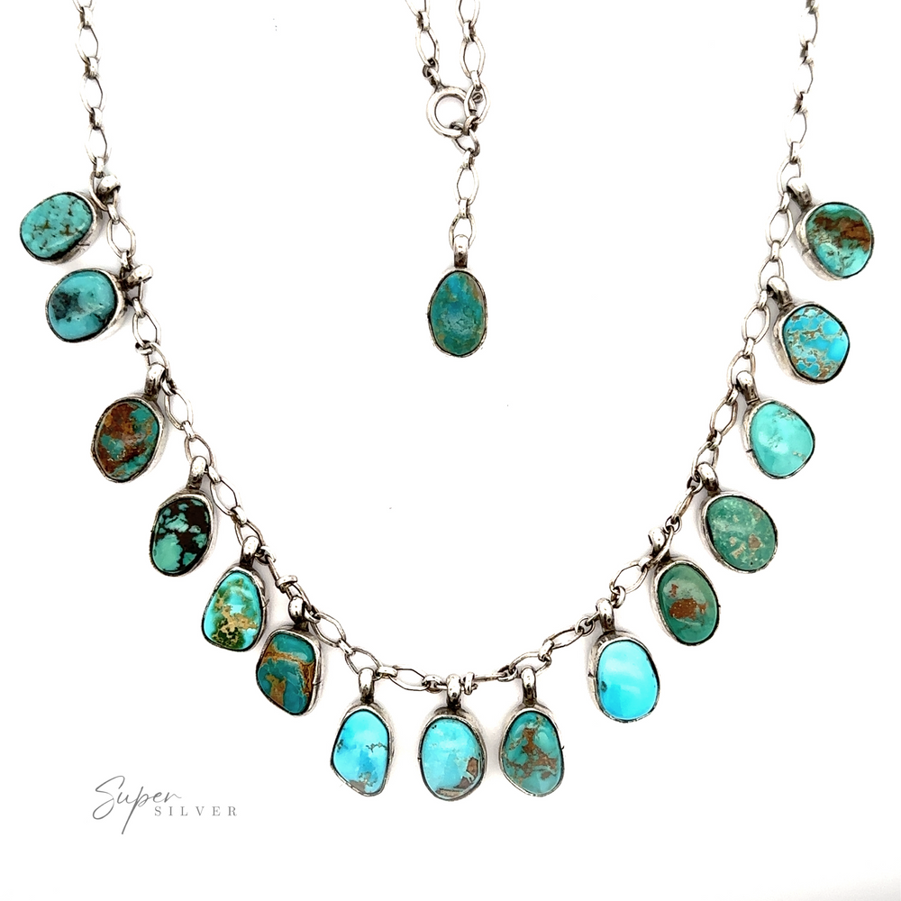 Handcrafted Charm Turquoise Necklace with multiple natural turquoise stones in varying shapes, arranged in a descending pattern, against a white background.