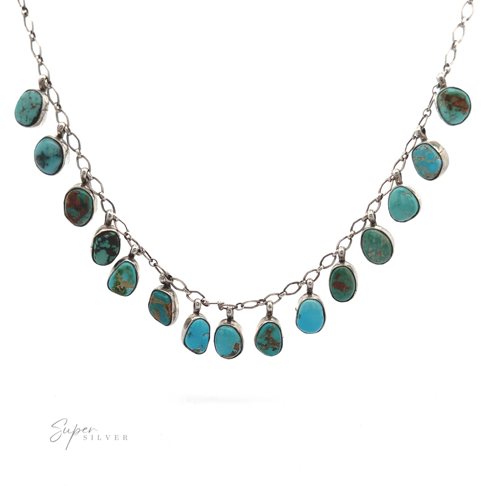 
                  
                    Handcrafted Charm Turquoise Necklace with multiple turquoise stones in various shapes, displayed on a white background.
                  
                