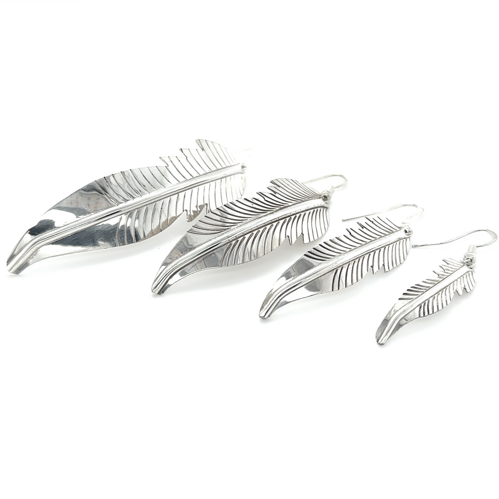 Three Super Silver Striking Native American Feather Earrings on a white background.