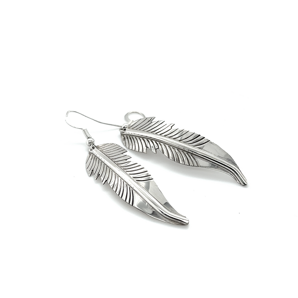 
                  
                    A pair of Super Silver Striking Native American Feather Earrings on a white background.
                  
                