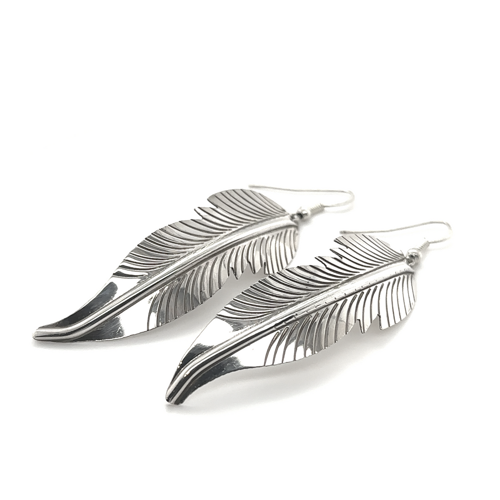 
                  
                    A pair of Super Silver Striking Native American Feather Earrings on a white background.
                  
                