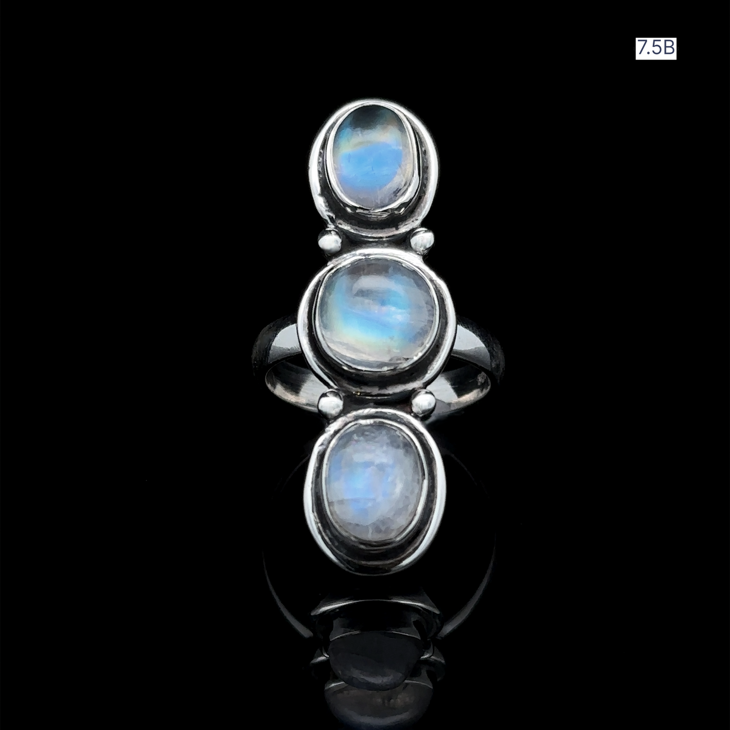 
                  
                    The Triple Moonstone Ring is a breathtaking piece crafted in sterling silver, featuring three vertically aligned oval moonstone cabochons set on a glossy black background, exuding goddess energy.
                  
                