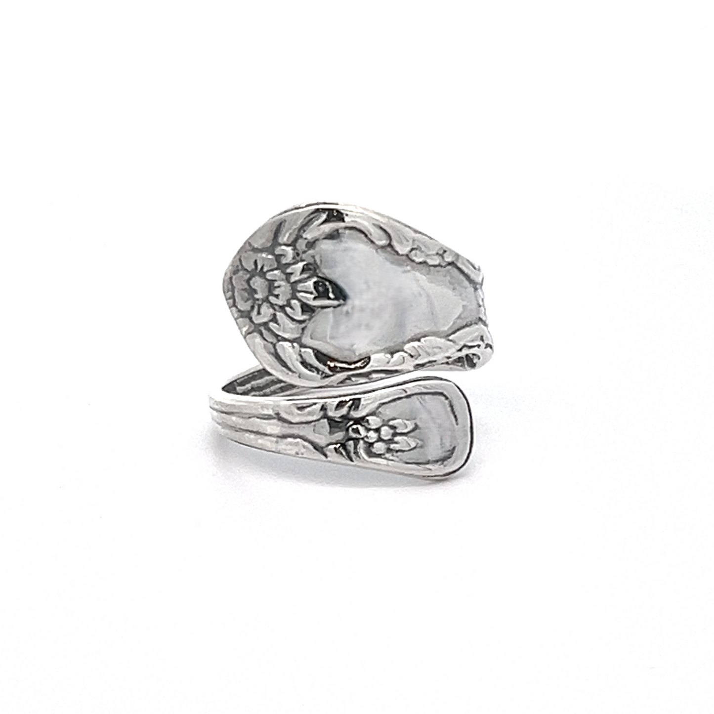 
                  
                    A Timeless Spoon Ring showcasing a floral pattern, with a coiled design where the handle forms the band, and finished with a polished touch.
                  
                