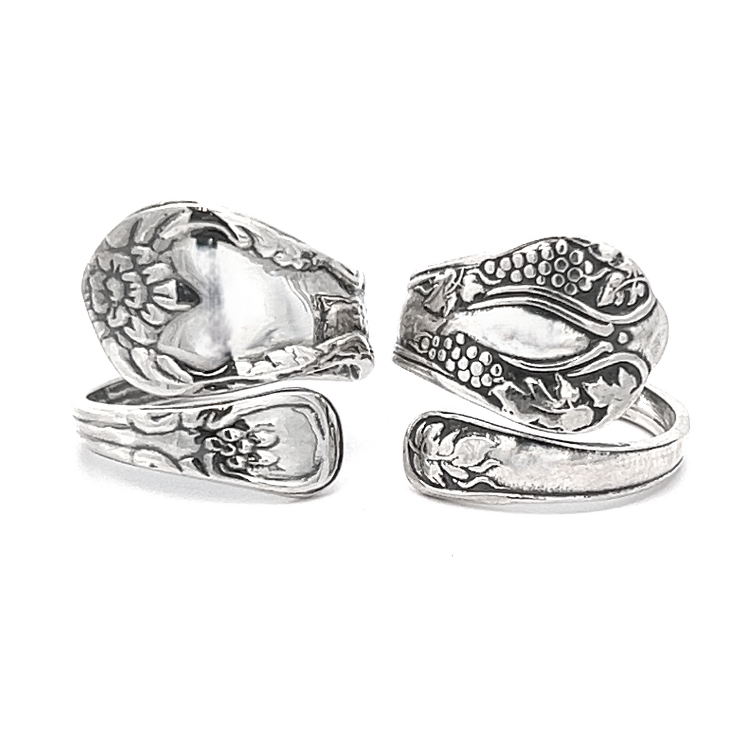 Two intricately designed Timeless Spoon Rings, adorned with a delicate grapevine motif and floral pattern, are displayed against a plain background.