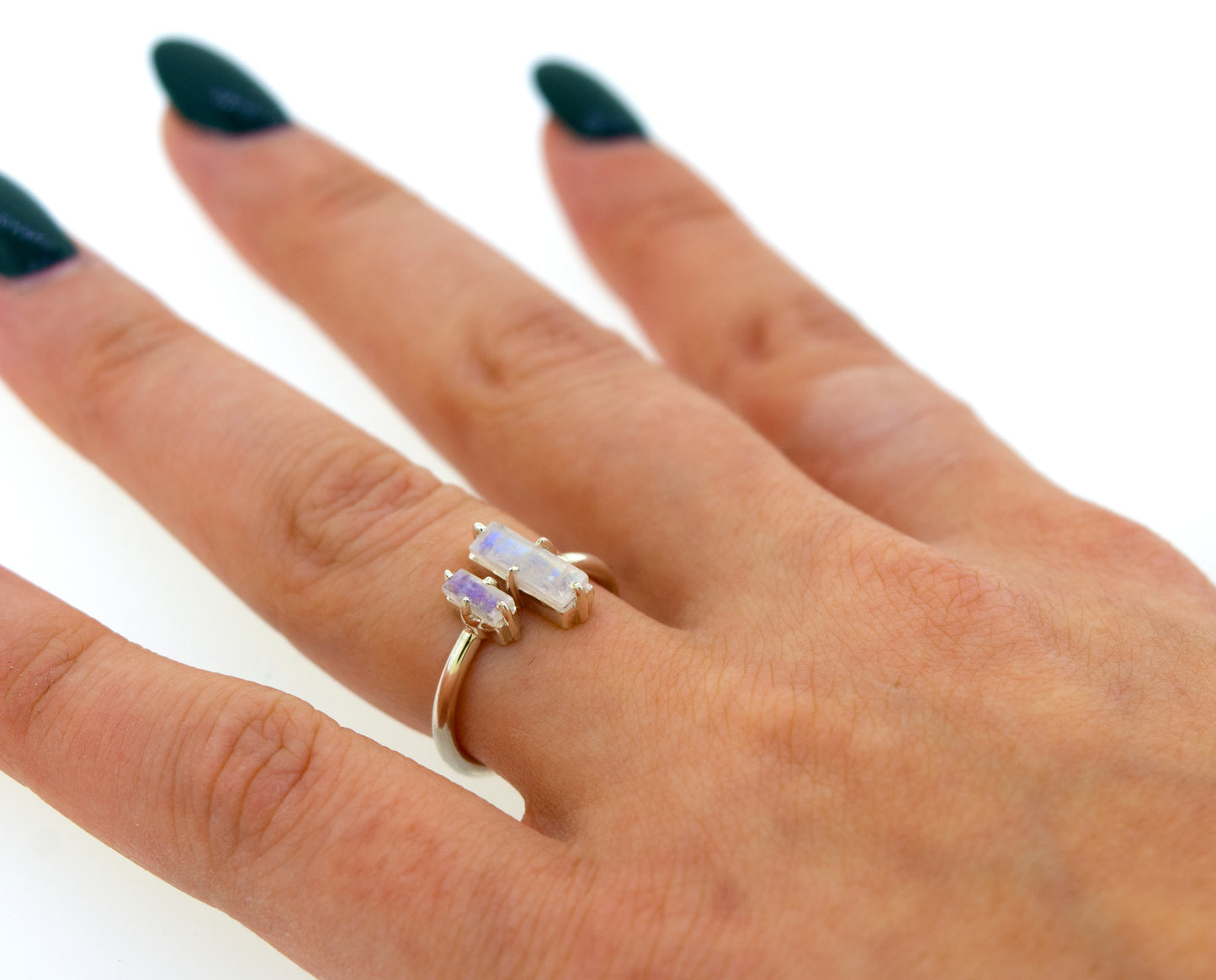 
                  
                    Close-up of a woman's hand displaying a Online Only Exclusive Adjustable Crystal Ring with a large, aurora crystal centerpiece on a simple band, against a white background.
                  
                